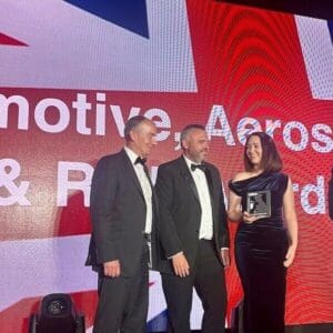 Sophie Hallett-Jones, Richard Hancox and Paul Turner from Accura Engineering receiving an award on stage at the 2025 Made in the UK Awards.